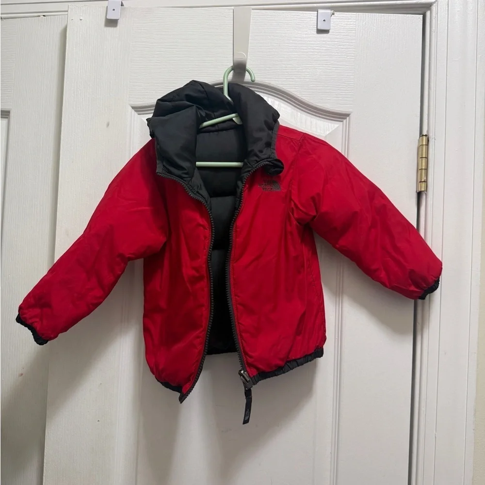 The North Face Kids Black and Red Puffer Jacket. Two-sided black and red